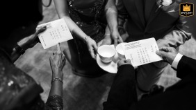 At the Four Seasons Bangkok, during a tea ceremony, a black and white detail shot captures hands gracefully holding cups, emphasizing the tradition and intimacy of the moment.